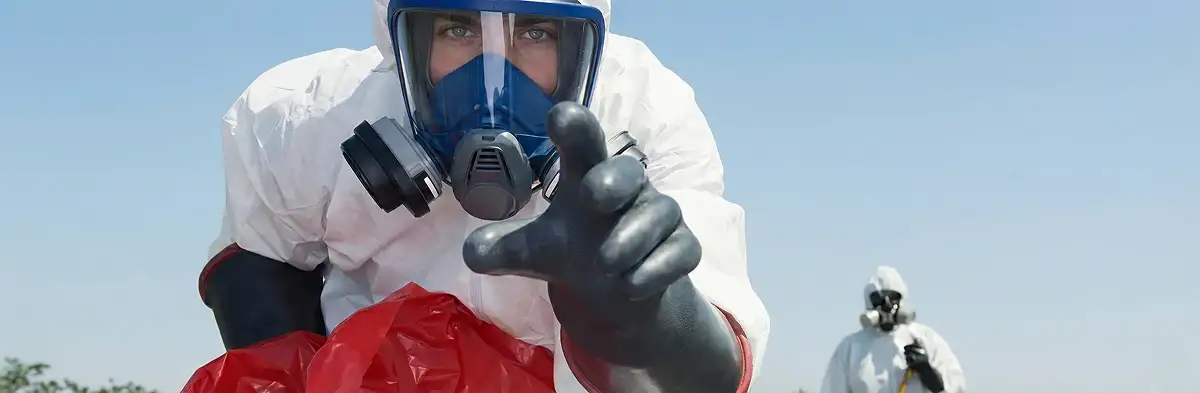 sewage clean up technician wearing protective gear handling biohazard materials in Chicago, IL
