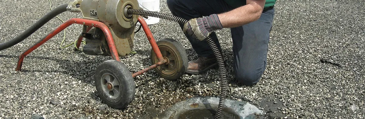 sewer rodding technician actively removing blockages from a sewer line in Chicago, IL