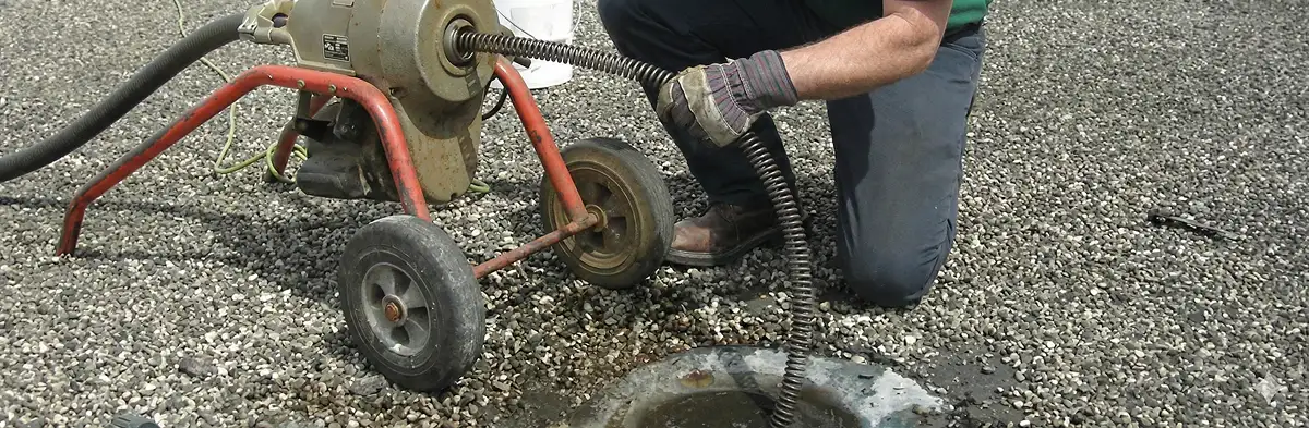 sewer rodding technician actively removing blockages from a sewer line in Chicago, IL